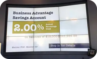 A video wall showing a savings rate in a bank branch